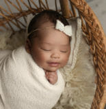 newborn baby girl smiling profession photo shoot