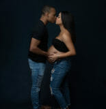 kissing maternity couple pose