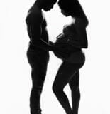 silhouette couple looking at baby bump