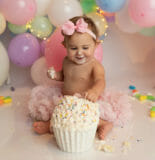 smiling baby girl cake smash photo session