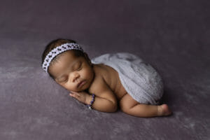 purple newborn girl setup with memory bracelet