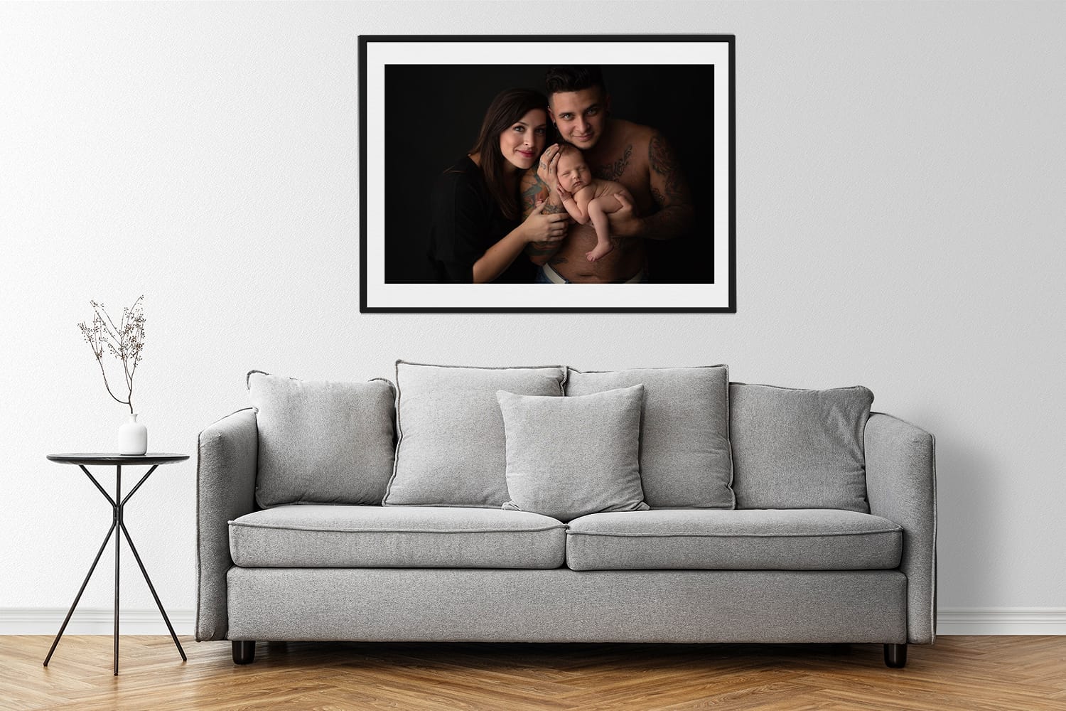 modern armchair in a minimal decor living room with wall art photo of new parents with baby boy
