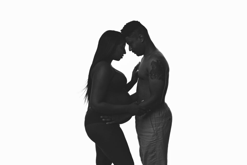 An expecting couple silhouette in the studio with Lafayette fertility clinics.