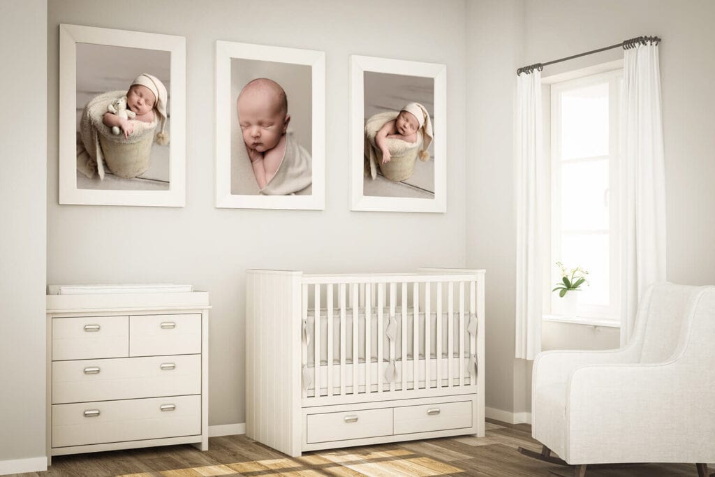 A bright, modern nursery with white furniture, including a crib, dresser, changing table, and armchair. Three framed baby photos hang above the crib. Sunlight enters through a window with white curtains. Melinda Gilmore Photography - Maternity & Newborn Photographer - Louisiana