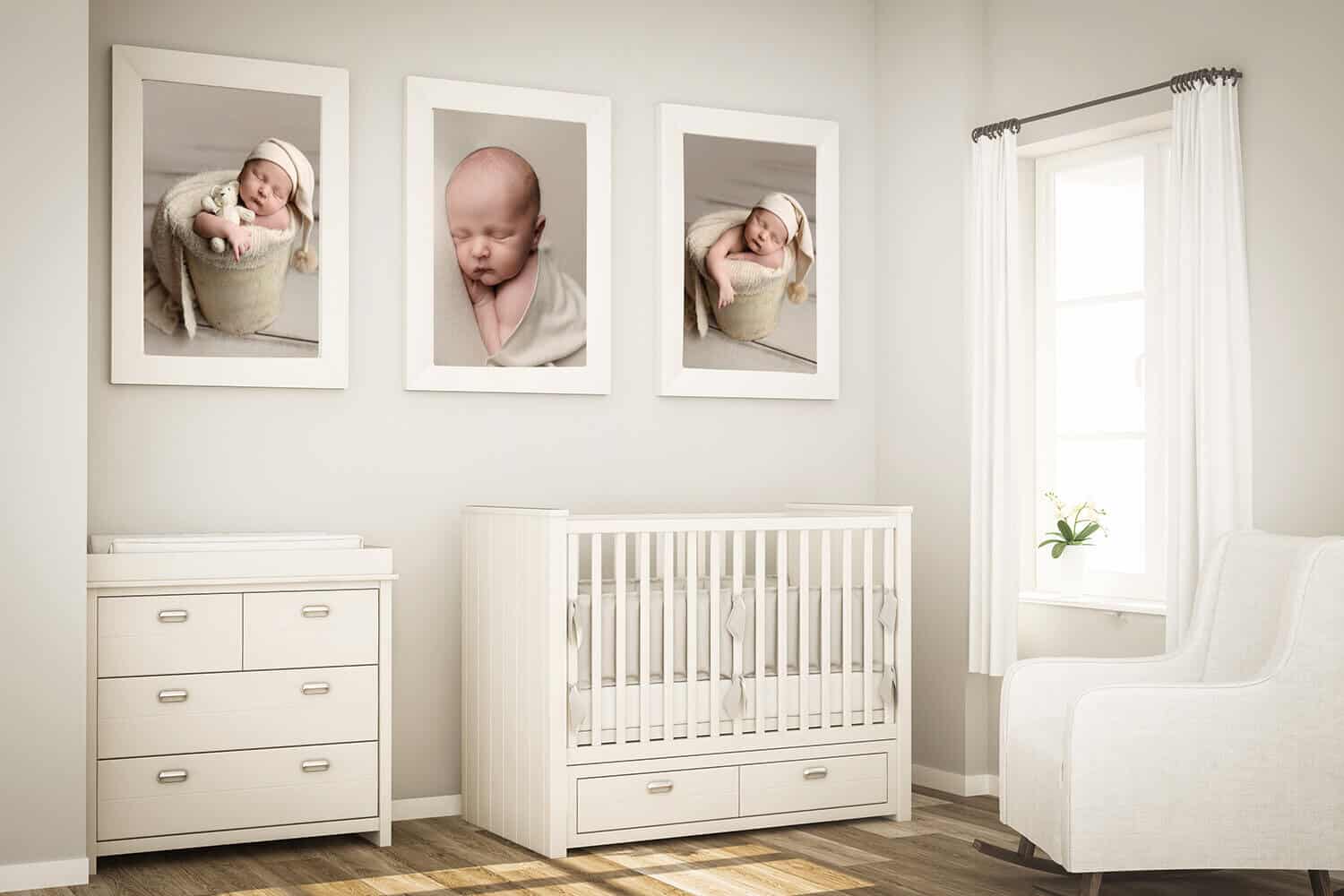 A bright, modern nursery with white furniture, including a crib, dresser, changing table, and armchair. Three framed baby photos hang above the crib. Sunlight enters through a window with white curtains. Melinda Gilmore Photography - Maternity & Newborn Photographer - Louisiana